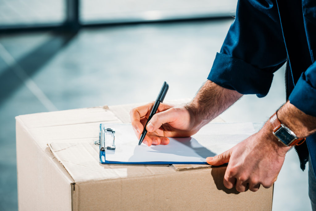 a decorative picture of a man taking notes in a warehouse